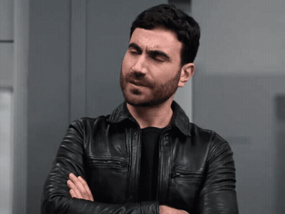 A Man In A Black Leather Jacket Is Making A Face GIF