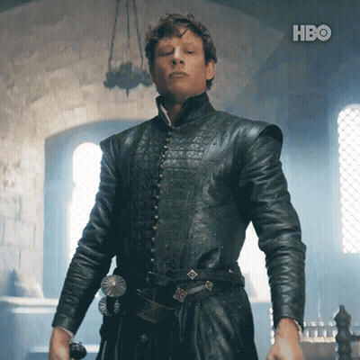 A Man In A Black Leather Jacket Is Standing In Front Of A Hbo Logo GIF