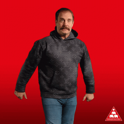 A Man In A Black Louis Vuitton Hoodie Gives Two Thumbs Up In Front Of A Red Background GIF