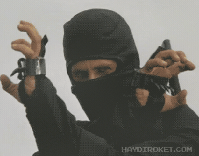 A Man In A Black Mask Is Holding A Gun With Haydiroket.com Written On The Bottom Right GIF