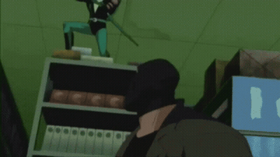 A Man In A Black Mask Is Standing In Front Of A Shelf With Binders GIF