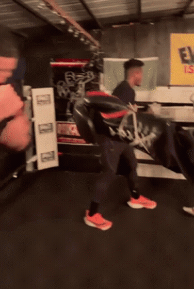 A Man In A Black Nike Shirt Is Boxing GIF