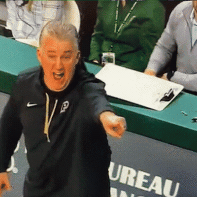 A Man In A Black Nike Sweatshirt Stands In Front Of A Sign That Says Ureau GIF
