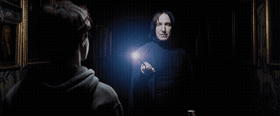 A Man In A Black Robe Is Pointing At Another Man GIF