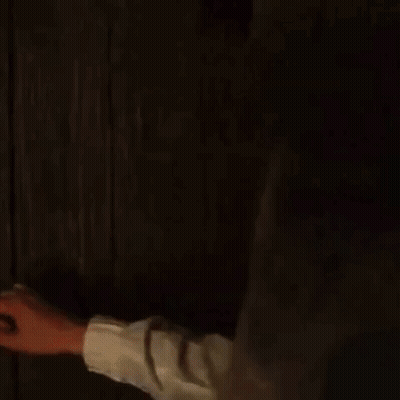 A Man In A Black Robe Is Standing In A Dark Room And Asking How 'S It Going . GIF