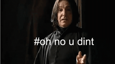 A Man In A Black Robe Is Standing In Front Of A Wall . GIF