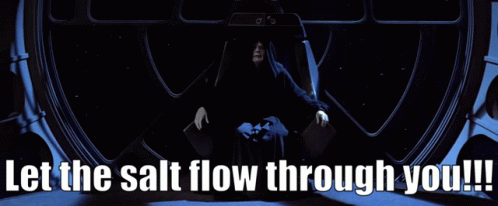 A Man In A Black Robe Sits In A Chair With The Words Let The Salt Flow Through You GIF