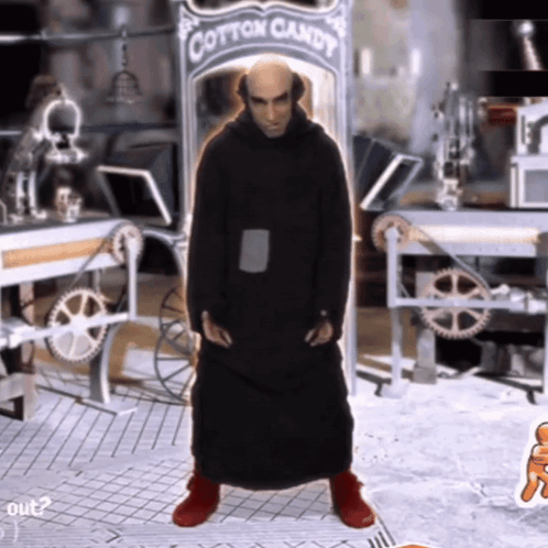 A Man In A Black Robe Stands In Front Of A Cotton Candy Sign GIF