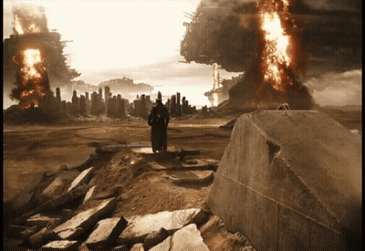 A Man In A Black Robe Stands On A Rock In Front Of A Burning City GIF
