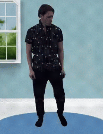 A Man In A Black Shirt And Black Pants Is Standing On A Blue Rug In A Room . GIF