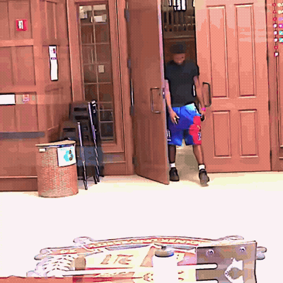 A Man In A Black Shirt And Blue Shorts With The Number 2 On Them GIF