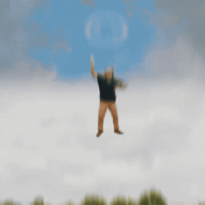 A Man In A Black Shirt And Brown Pants Is Jumping In The Air GIF