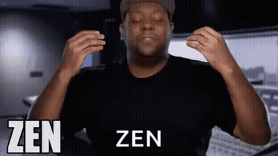 A Man In A Black Shirt And Hat Is Making A Zen Gesture With His Hands . GIF