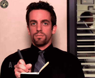 A Man In A Black Shirt And Tie Is Writing In A Notebook With A Starbucks Logo In The Corner GIF
