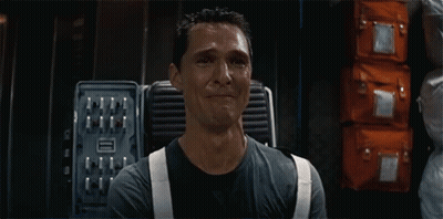 A Man In A Black Shirt And White Suspenders Is Crying In A Room GIF