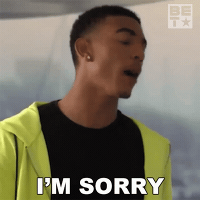 A Man In A Black Shirt And Yellow Jacket Is Saying I 'M Sorry GIF