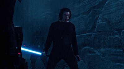 A Man In A Black Shirt Holds A Blue Light Saber GIF