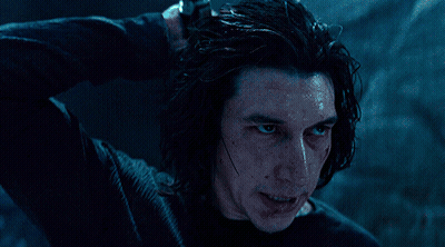 A Man In A Black Shirt Holds A Light Saber GIF