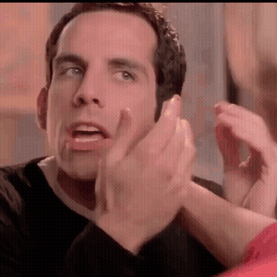 A Man In A Black Shirt Is Clapping His Hands In A Close Up Of His Face . GIF
