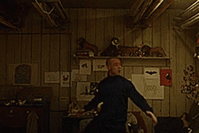 A Man In A Black Shirt Is Dancing In A Room GIF