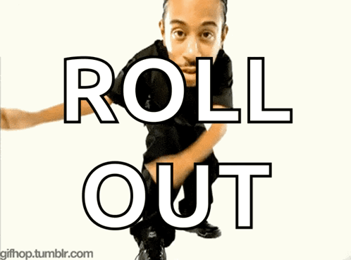 A Man In A Black Shirt Is Dancing In Front Of A Sign That Says Roll Out GIF