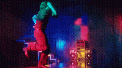 A Man In A Black Shirt Is Dancing In Front Of A Stack Of Speakers With The Letter O On Them GIF