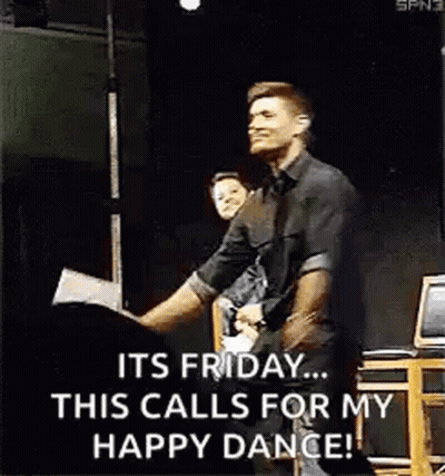 A Man In A Black Shirt Is Dancing On A Stage . GIF