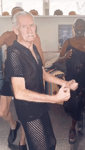 A Man In A Black Shirt Is Dancing With A Woman GIF