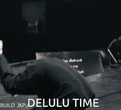 A Man In A Black Shirt Is Doing A Handstand With The Words Build Jkp Delulu Time Behind Him GIF