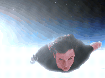 A Man In A Black Shirt Is Flying In The Sky GIF