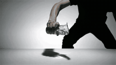 A Man In A Black Shirt Is Holding A Glass With The Word Coca Cola On It GIF