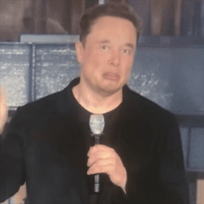 A Man In A Black Shirt Is Holding A Microphone And Making A Funny Face GIF