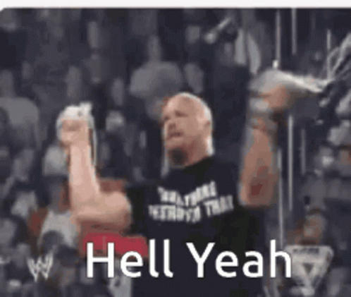A Man In A Black Shirt Is Holding A Microphone In Front Of A Crowd And Says `` Hell Yeah '' . GIF