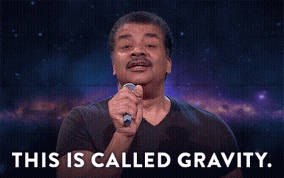 A Man In A Black Shirt Is Holding A Microphone In His Hand And Says This Is Called Gravity . GIF