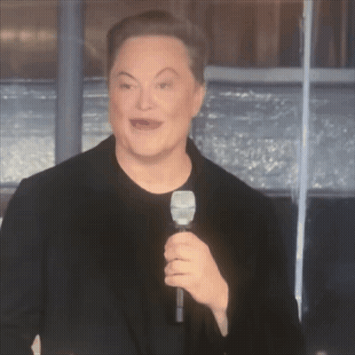 A Man In A Black Shirt Is Holding A Microphone GIF