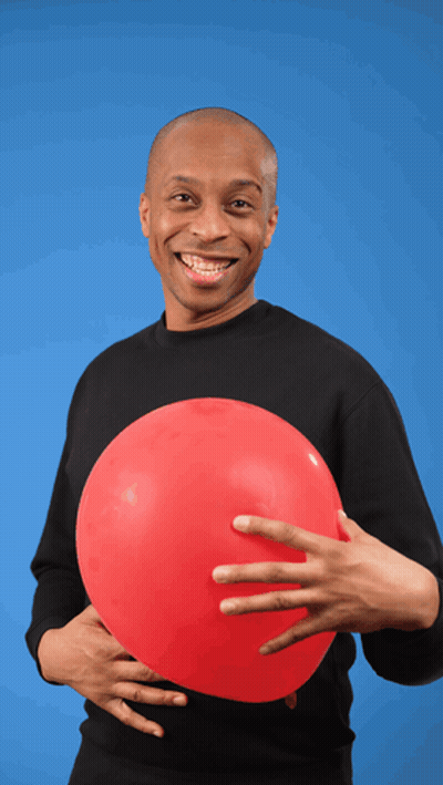 A Man In A Black Shirt Is Holding A Red Balloon In His Hand GIF
