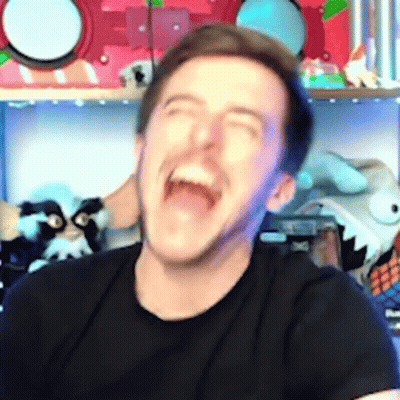 A Man In A Black Shirt Is Laughing With His Mouth Wide Open . GIF