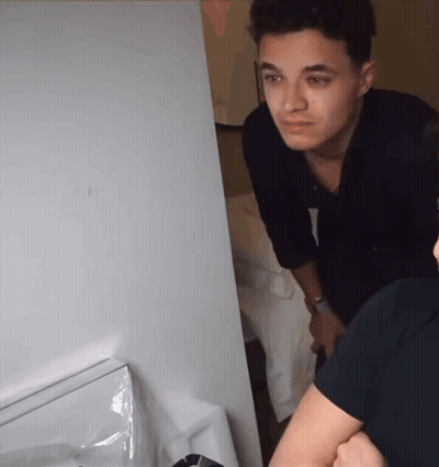 A Man In A Black Shirt Is Looking At Something GIF