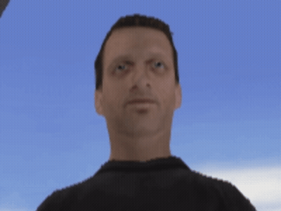 A Man In A Black Shirt Is Looking At The Camera With A Blue Sky In The Background GIF