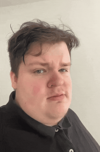 A Man In A Black Shirt Is Making A Face GIF