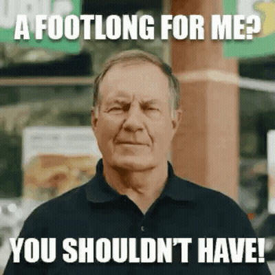 A Man In A Black Shirt Is Making A Funny Face While Standing In Front Of A Subway Sign . GIF