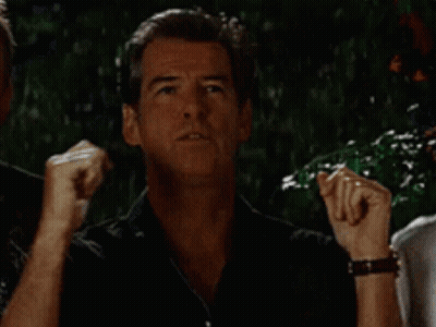 A Man In A Black Shirt Is Making A Funny Face While Standing Next To Another Man . GIF