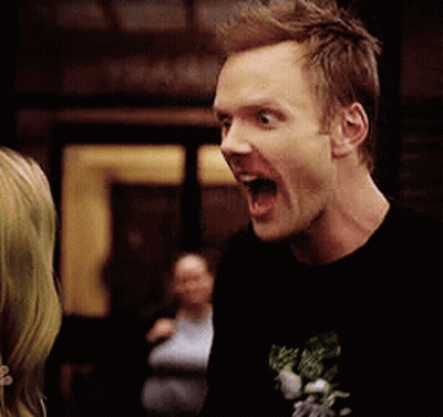 A Man In A Black Shirt Is Making A Funny Face With His Mouth Wide Open GIF