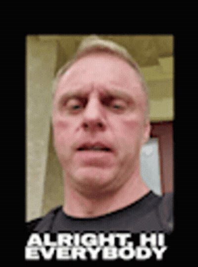 A Man In A Black Shirt Is Making A Funny Face With The Words `` Alright Hi Everybody '' Above Him . GIF