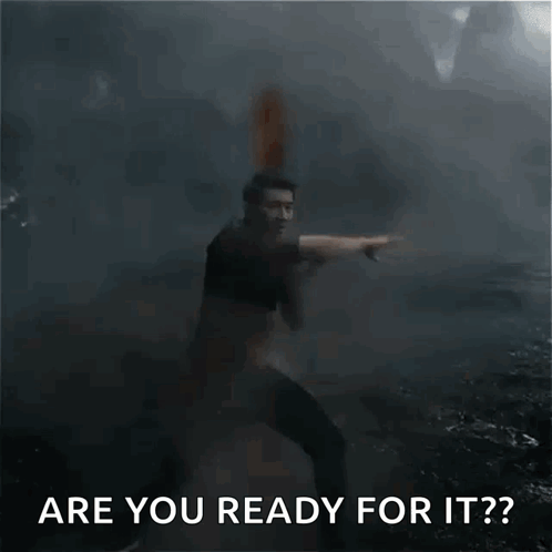 A Man In A Black Shirt Is Pointing At Something In The Dark . GIF