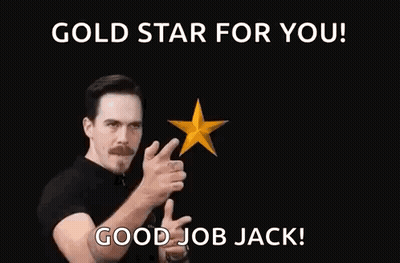 A Man In A Black Shirt Is Pointing At Two Gold Stars With His Fingers . GIF