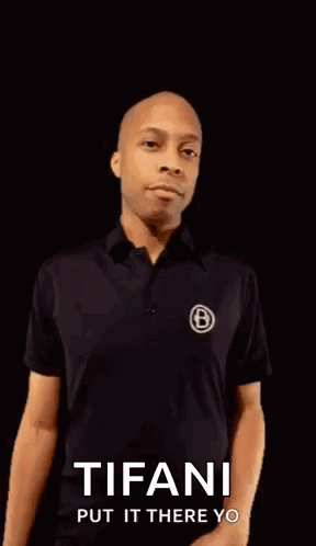 A Man In A Black Shirt Is Pointing His Fist At The Camera With The Words Tifani Put It There Yo On The Bottom . GIF