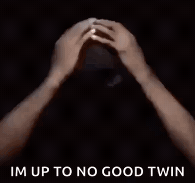 A Man In A Black Shirt Is Saying `` Im Up To No Good Twin '' In A Dark Room . GIF