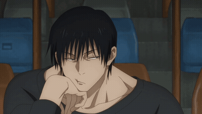 A Man In A Black Shirt Is Sitting In A Chair GIF