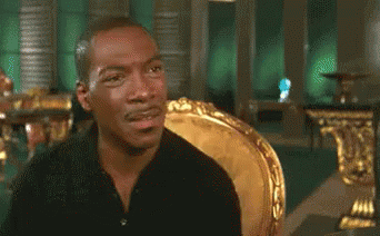 Man In Black Shirt Sitting In Gold Chair GIF